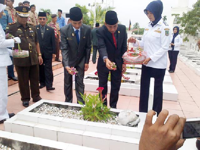 Wakil Bupati Erianda dan Ketua DPRD Nasrudin Hasan menabur bunga ditaman makam pahlawan. foto : Andi